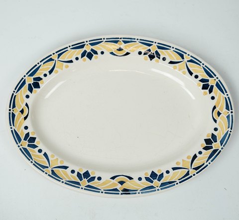 Large dinner plate decorated with blue and yellow colours from the 1960s. 
5000m2 showroom.