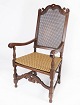 Antik armstol af eg, med original polstring af lyst stof og rørflet, fra 
1920erne.
5000m2 udstilling.